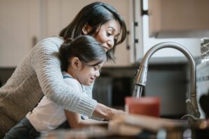 mother-and-daughter-using-kitchen-sink